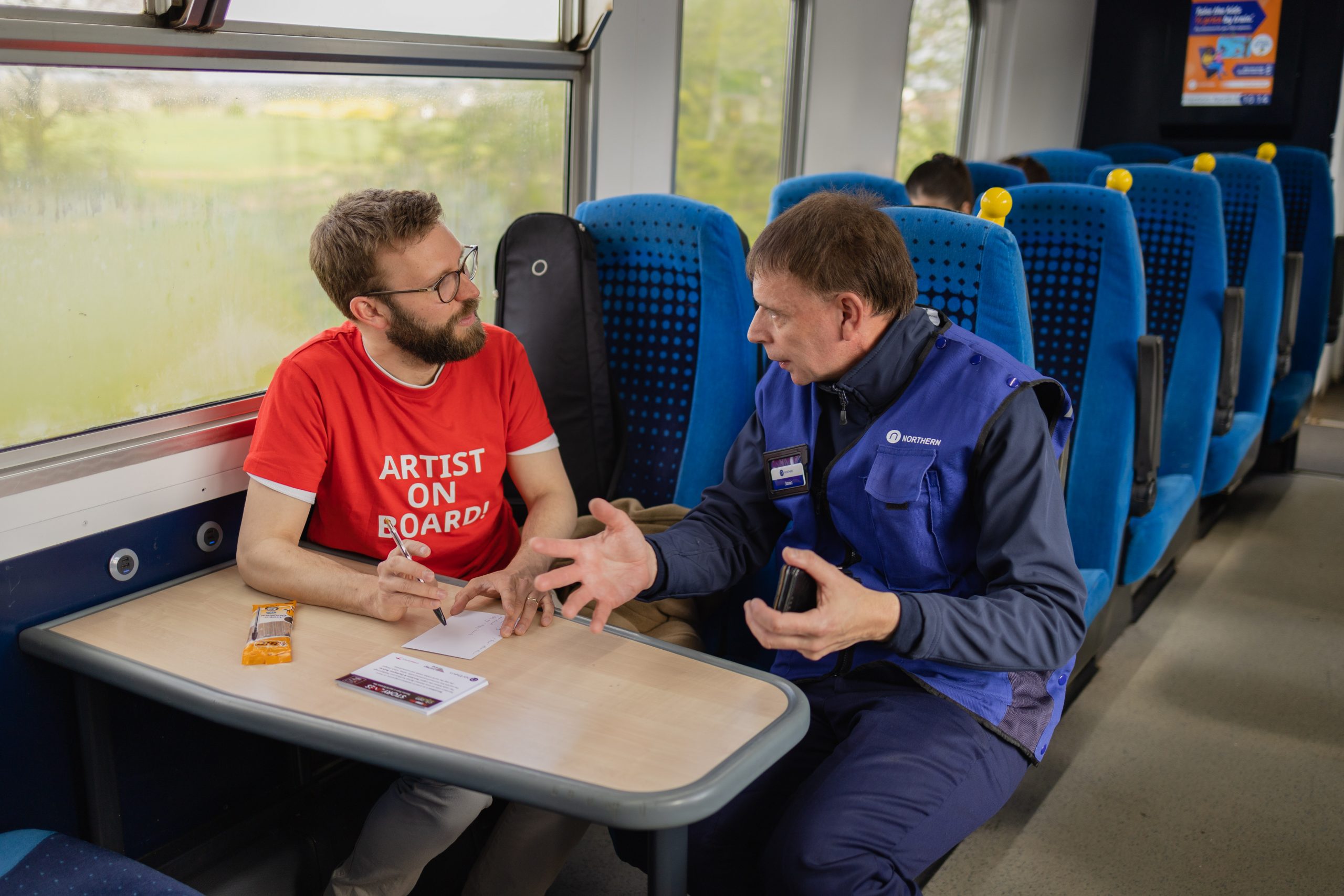 Sam Slatcher talking to a Northern conductor on the train