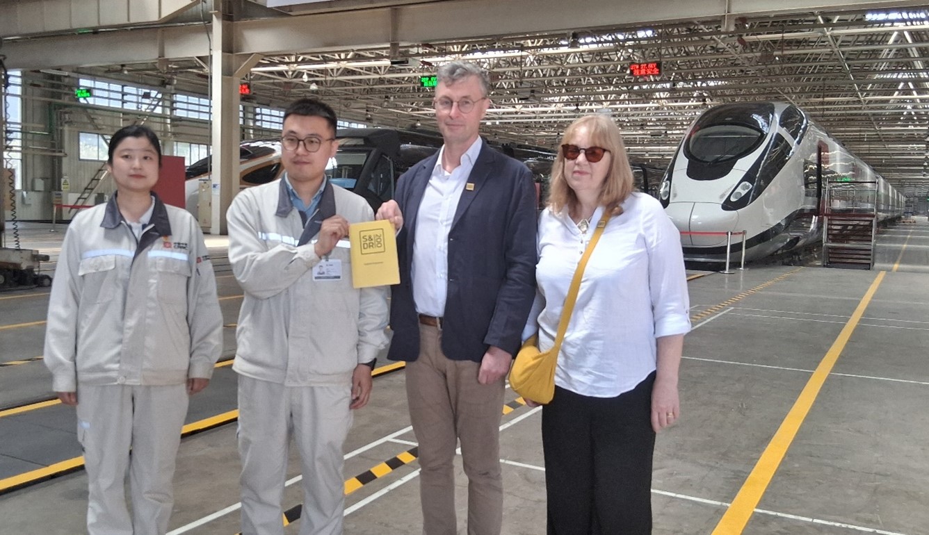 Niall and Caroline with S&DR200 festival programme at the Tangshan Locomotive Works.
