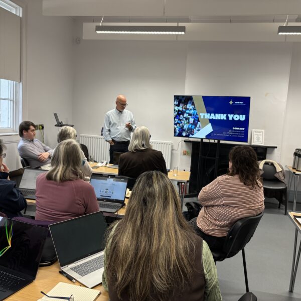 trainer standing infront of group of people teaching them about AI