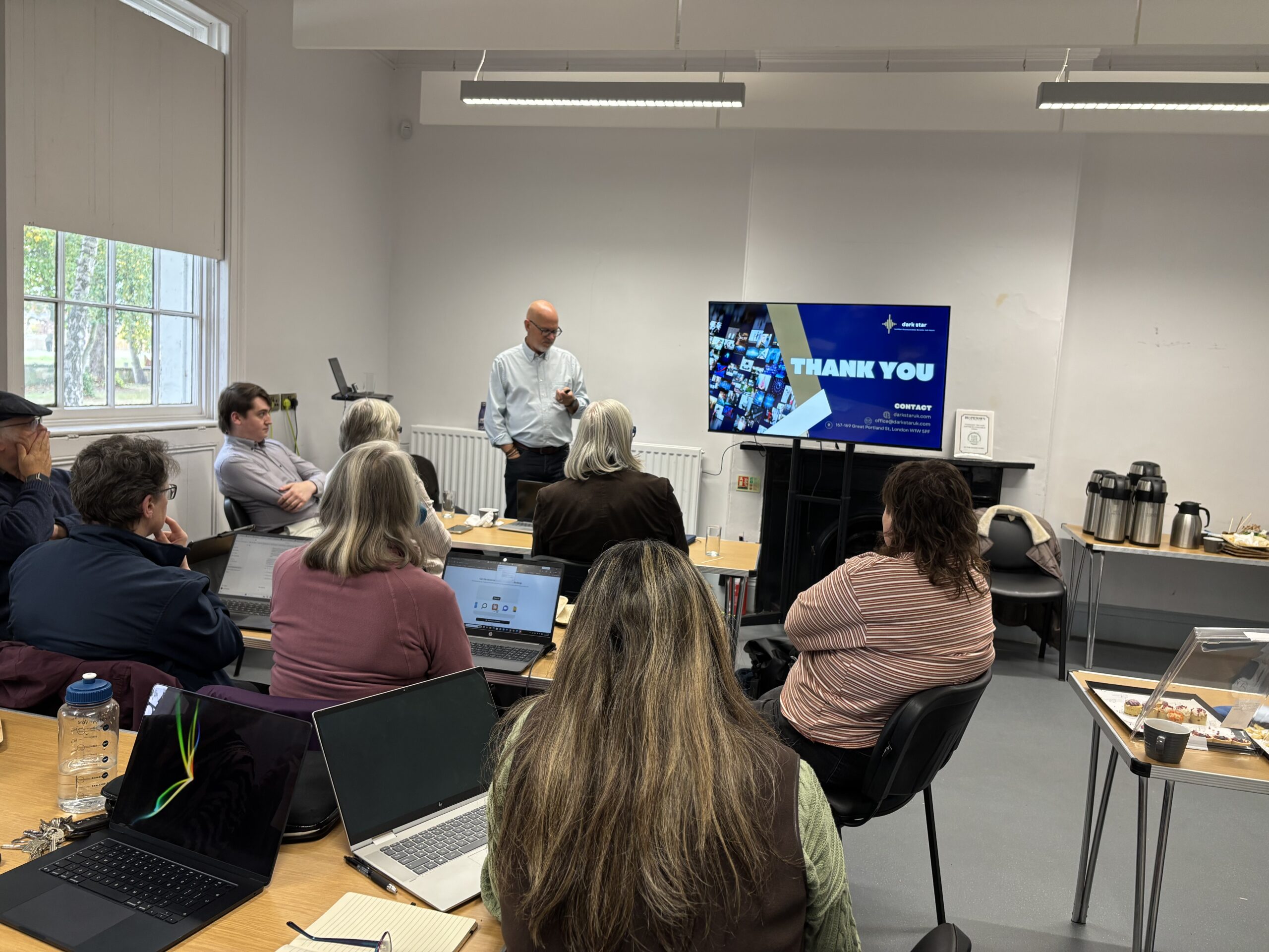 trainer standing infront of group of people teaching them about AI